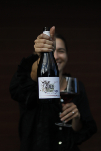Leefield Station Pinot Noir – Beauty – Woman holding bottle